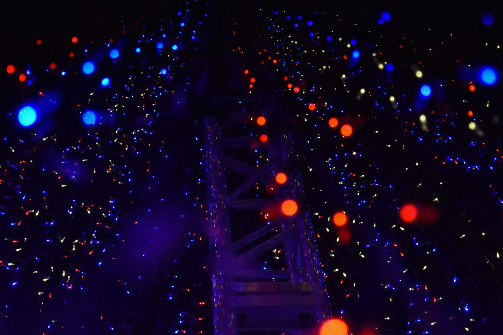 Night sky illuminated by a drone light show with vivid colors